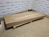 a pile of wood sitting on a pallet in a room