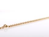 a close up of a gold chain on a white surface