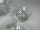 two clear glass bowls sitting on a white table