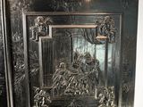 a large black fireplace with a decorative design on it