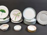 many plates and bowls sitting on a black table