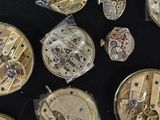 many different types of watches on a black surface