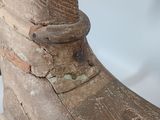 an old wooden shoe is sitting on top of a white surface
