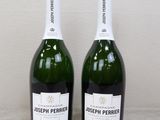 two bottles of champagne sitting next to each other on a table