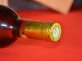 a bottle of wine sitting on a red table