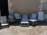 four chairs and a table in front of a building