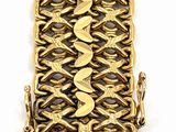 a close up of a gold bracelet on a white background