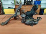 a statue of a woman and a bird on a table