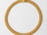 a gold necklace on a white background
