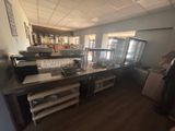 a photo of a restaurant kitchen with a lot of counter space