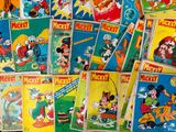 several mickey mouse comics are stacked on top of each other
