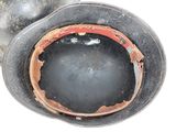 a close up of a black vase with a hole in it