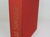 the book is red with gold lettering on the front of it
