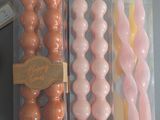 a bunch of different colored candles in a box