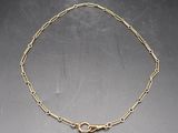 a gold chain bracelet with a link and a clasp