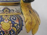a vase with a bird on it sitting on a table