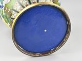 a blue vase with a gold rim on a white background