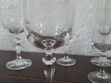 several empty wine glasses sitting on top of a wooden table