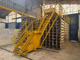 a yellow staircase going up to the top of a building