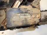 a close up of a chainsaw on a white surface