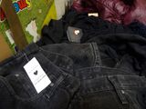 a pile of clothes and a cell phone on a table
