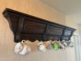 a shelf with a bunch of cups hanging on it