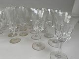 many wine glasses lined up on a white table