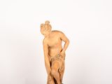 statue of a man leaning on a rock on a white background