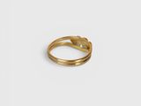 a close up of a gold ring on a white background