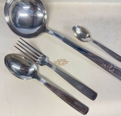 three spoons and two spoons sitting on a counter