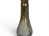 a green glass vase with a design on it