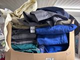 a cardboard box full of clothes and a pair of shoes
