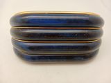 three blue and gold bracelets stacked on top of each other on a white surface