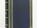 a blue book with gold trimming and a black cover