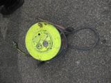 a yellow frisbee laying on the ground next to a pair of black shoes
