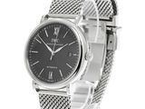 an image of a wrist watch with a black dial and a silver mesh band