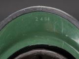 a close up of a green vase with a black base