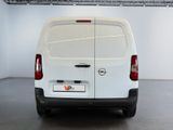the back end of a white van parked in a garage