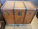 a brown trunk sitting on top of a table