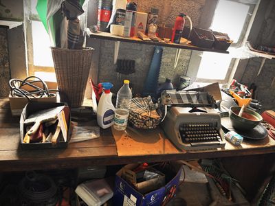 a desk with a typewriter, a typewriter, and other items on it