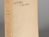 an old book sitting on top of a table on a gray surface