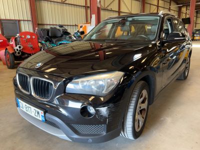 a picture of a black bmw suv parked in a garage