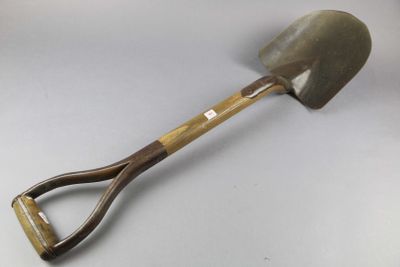 a shovel with a wooden handle on a white surface