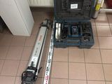a tool set up on the floor next to a tool box