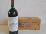 a bottle of wine that is sitting next to a wooden box