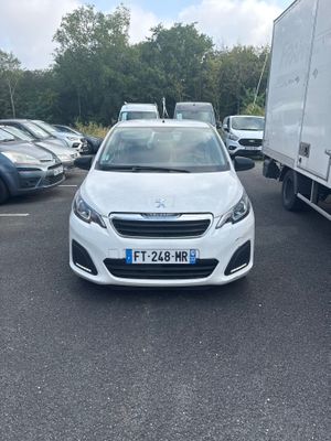 a white car parked in a parking lot next to a truck