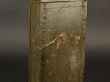 a small metal box with a handle on a black background