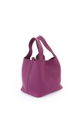 a purple leather bag with a zipper on the front