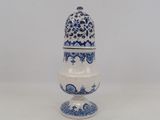 a small blue and white vase with a bird on it