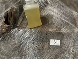 a bottle of liquid sitting on a table covered in plastic